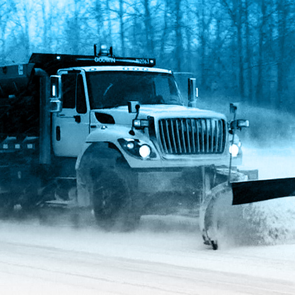 Snow plow clearing a road.